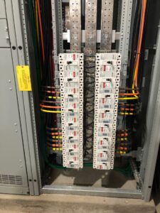 Interior view of a residential electrical panel with circuit breakers and wiring by Patriot Electric L.L.C in Phoenix, AZ