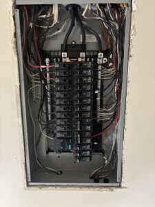 Detailed view of a residential electrical panel with organized wiring and circuit breakers by Regal Electrical Services in West Jordan, UT.
