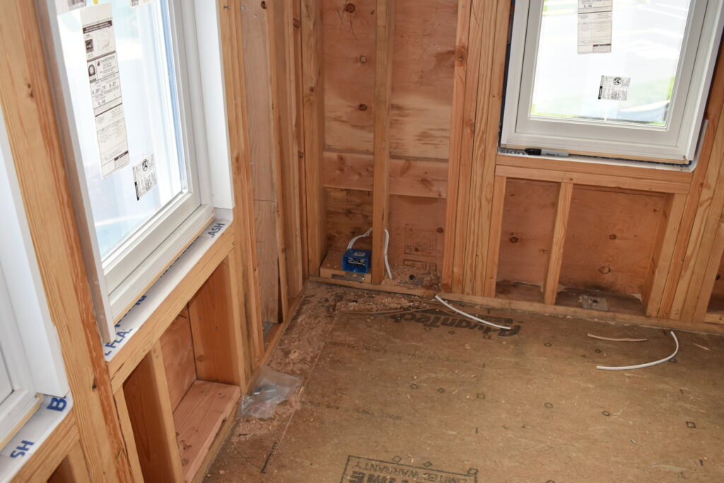 Rough-in electrical wiring and outlet boxes installed in a residential framed wall by Cardinal Electric in Sayreville, NJ