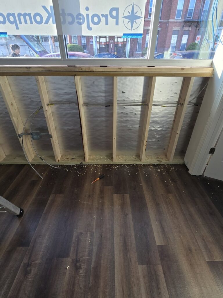 Electrical wiring and junction boxes installed in wooden wall framing during a residential project by DHJ Electric in Methuen, MA.