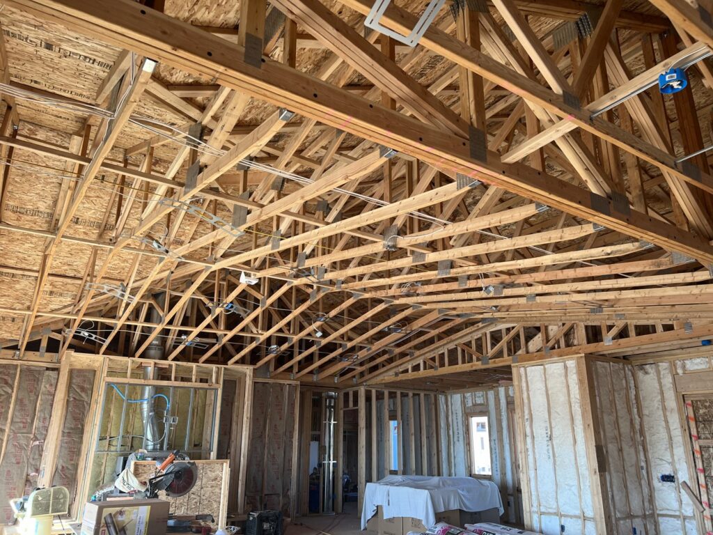 Residential electrical rough-in wiring within wooden framing during construction by P.H. Electric in Soulsbyville, CA.