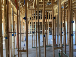 Residential electrical rough-in wiring and blue junction boxes in a new home by TJAM Electric in Springtown, TX.