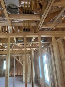 Residential electrical rough-in wiring installed within the wooden framing of a new home by Blevens Electric LLC in Bowling Green, KY
