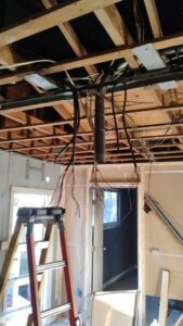 Exposed ceiling joists with new electrical rough-in wiring in a residential project by Envision Electrical Solutions in Fort Lauderdale, FL.
