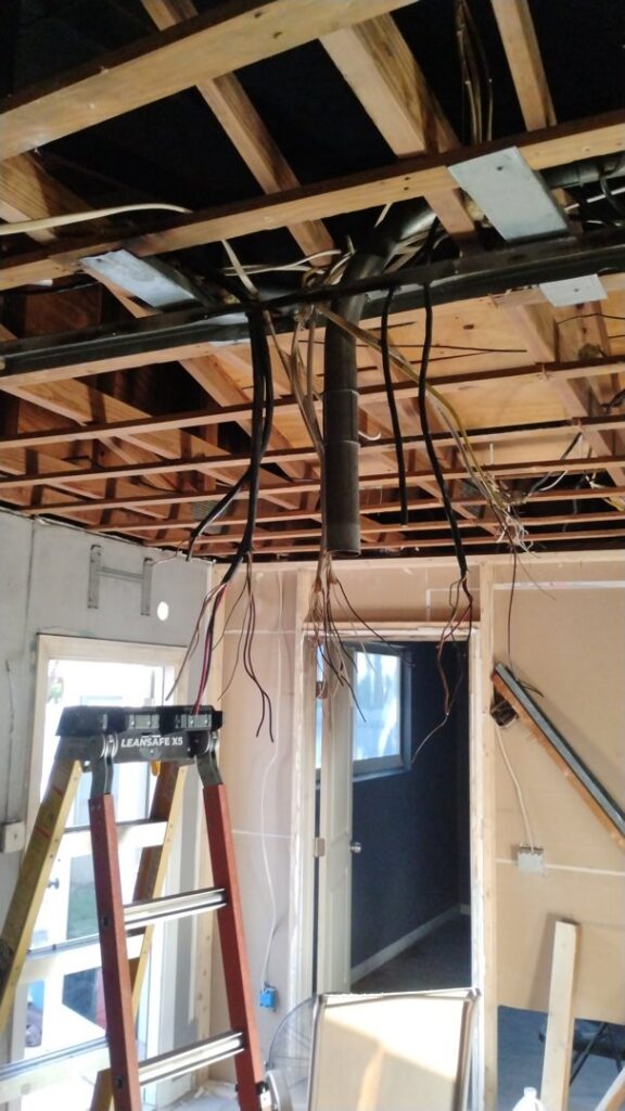 Exposed ceiling joists with new electrical rough-in wiring in a residential project by Envision Electrical Solutions in Fort Lauderdale, FL.