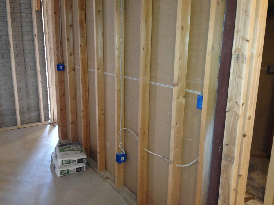 Residential electrical rough-in with wiring and blue boxes installed in wall studs by Zsori Electric in Waukesha, WI.