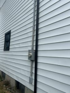 Residential electrical service installation with conduit and meter on a house exterior by D&M Master Electric LLC in Newark, NJ.