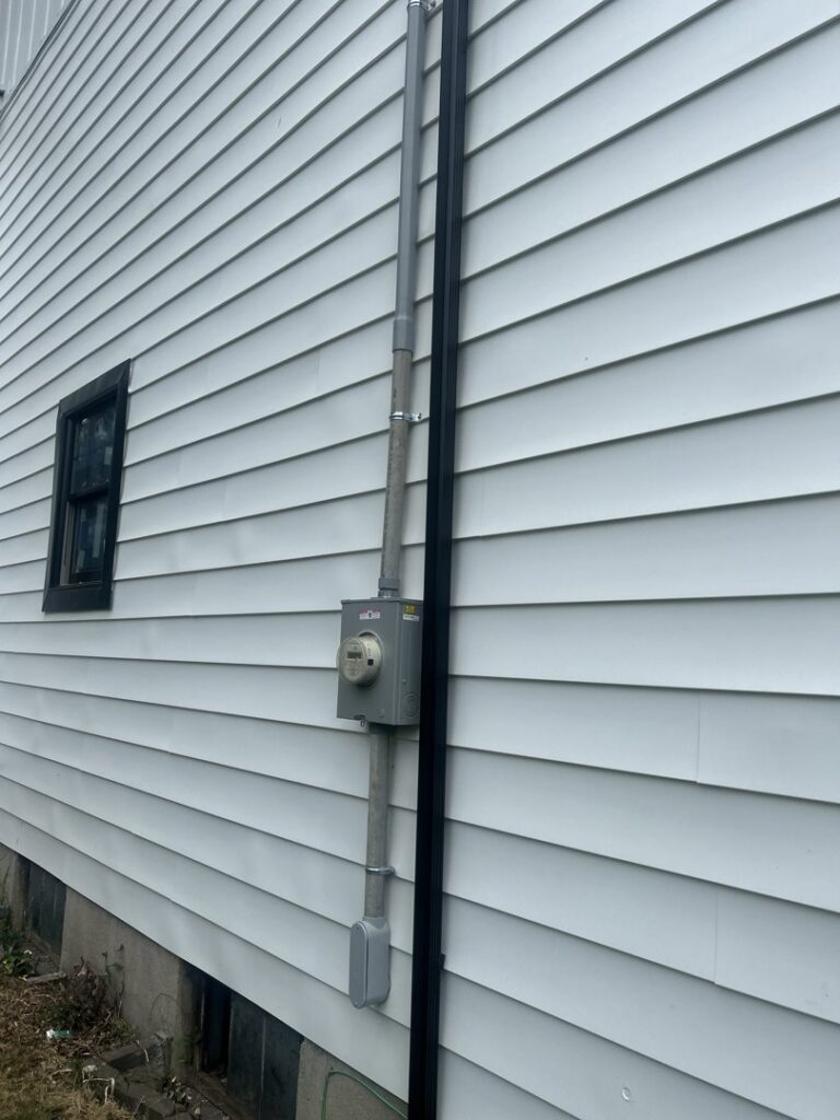 Residential electrical service installation with conduit and meter on a house exterior by D&M Master Electric LLC in Newark, NJ.