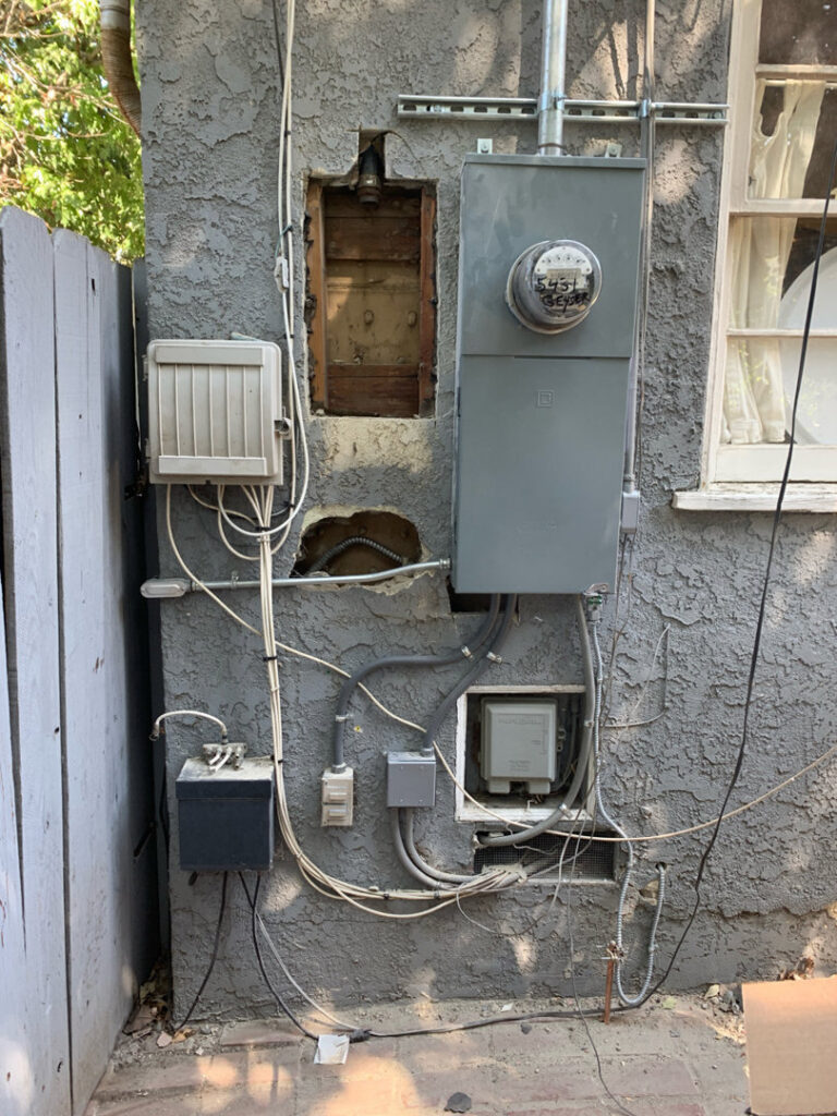 Exterior view of a residential electrical service panel and wiring on a house by Prime Electric in Bellevue, WA.