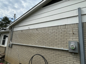 Residential electrical service upgrade with new meter and conduit on a brick house by Heritage Electric LLC in Indianapolis, IN.