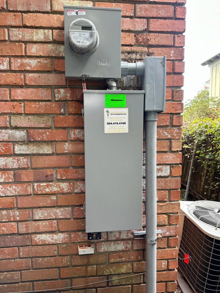 A residential electrical service panel and meter on a brick wall by Joule Electrical A/C & Heating Services in New Orleans, LA.