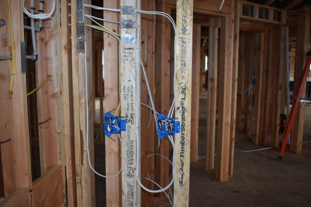 Residential electrical wiring and blue outlet boxes installed in framed walls by Cardinal Electric in Sayreville, NJ
