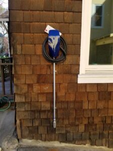A residential electric vehicle charger installed on a wooden shingle wall by Wisdom Electrical in San Francisco, CA.