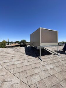 A large evaporative cooler unit installed on a residential rooftop, serviced by Anchor Air in El Paso, TX