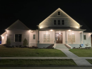 Residential home exterior illuminated by professional lighting installed by Hammett Electric, Inc. in Conway, AR.