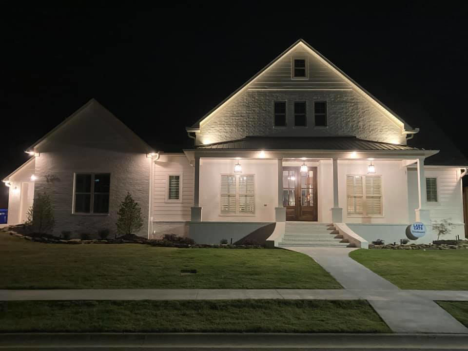 Residential home exterior illuminated by professional lighting installed by Hammett Electric, Inc. in Conway, AR.