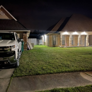 Residential exterior lighting service illuminating a home at night by Light of the World Electric in Lake City, FL.