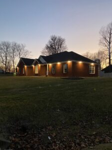 A residential home illuminated by newly installed exterior soffit lighting by Ace Electrical Services LLC in Owensboro, KY.