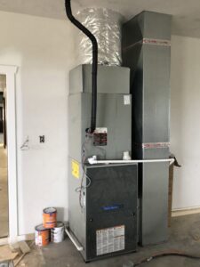 A residential furnace and ductwork installation in a utility room or garage by Crouch's Heating & Cooling LLC in Stillwater, OK.