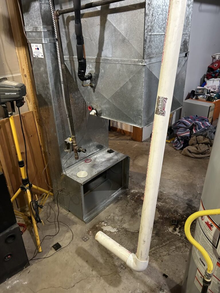 A residential furnace and HVAC unit with ductwork, representing services by Spartan Heating, Cooling and Fireplaces in Cedar Rapids, IA