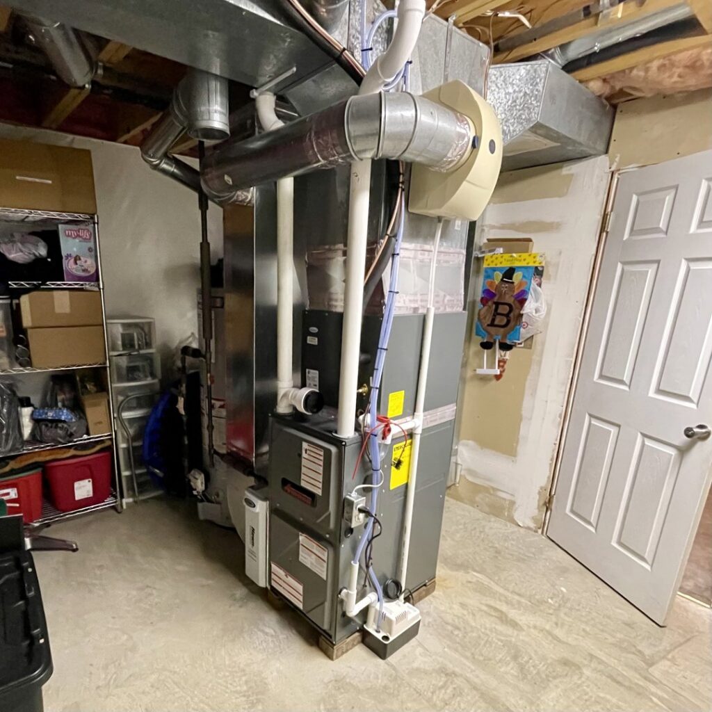 A residential furnace and air handler unit with ductwork, installed by Hawn Heating and Air Conditioning in Rochester, NY.