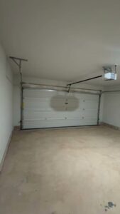 A residential garage door and opener system from the interior, installed by 405 Garage Pros in Edmond, OK.