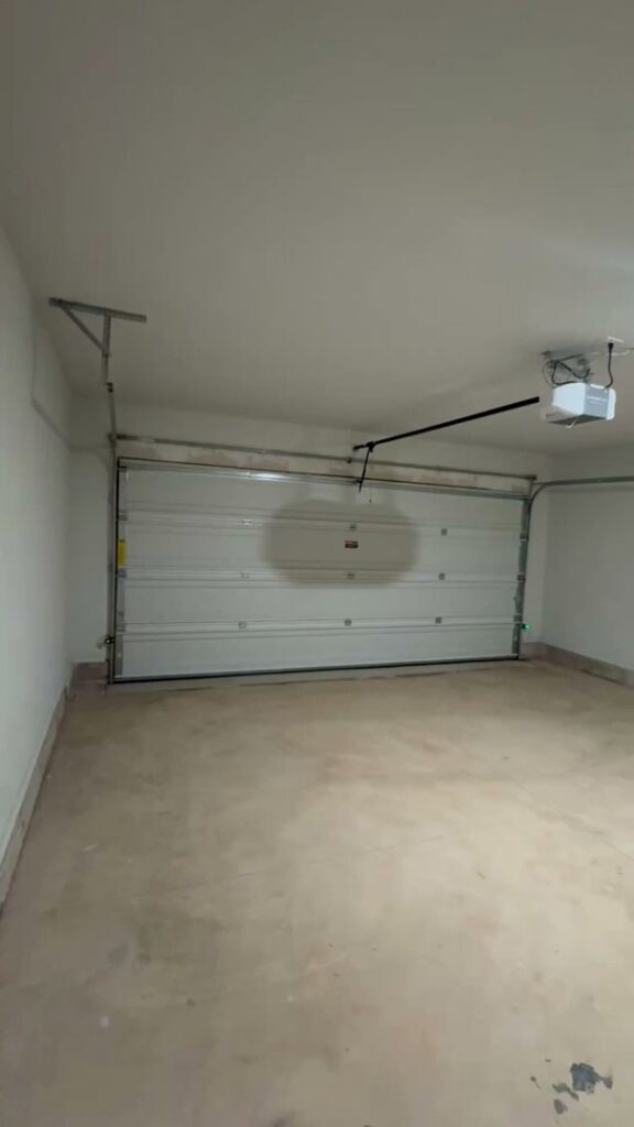 A residential garage door and opener system from the interior, installed by 405 Garage Pros in Edmond, OK.