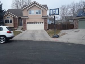 A residential house featuring a newly installed garage door by Front Range Raynor Garage Door & Service in Fort Collins, CO.