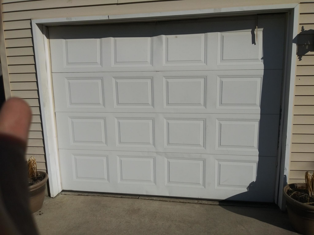 A newly installed white residential garage door by Codiwayne Construction & Door in South Bend, IN.