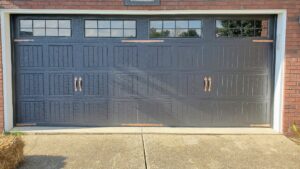 A newly installed residential garage door with decorative hardware and windows by Honest Overhead Garage Doors in Elizabethtown, KY.