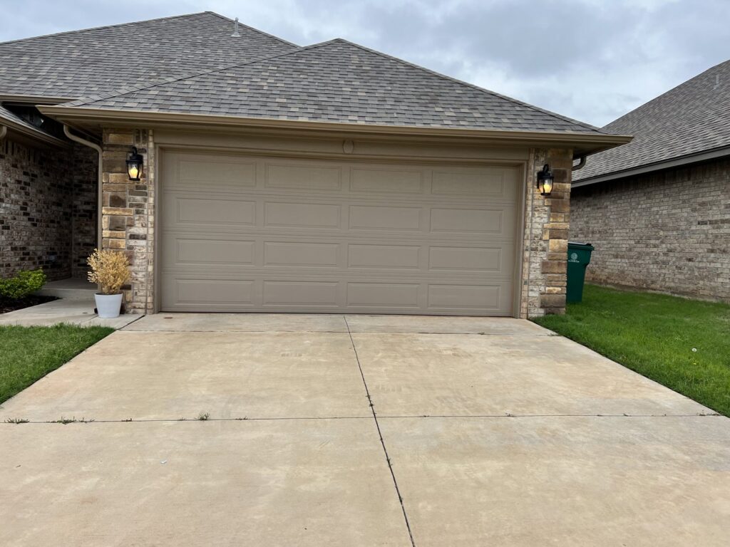 A newly installed residential garage door completed by Rhino Garage Doors LLC OKC in Edmond, OK.