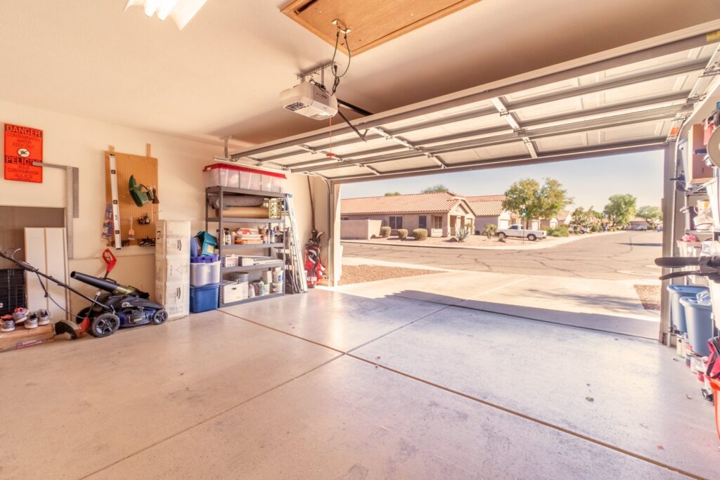 An open residential garage door and opener, representing services from Fort Wayne Door & Dock, Inc. in Fort Wayne, IN