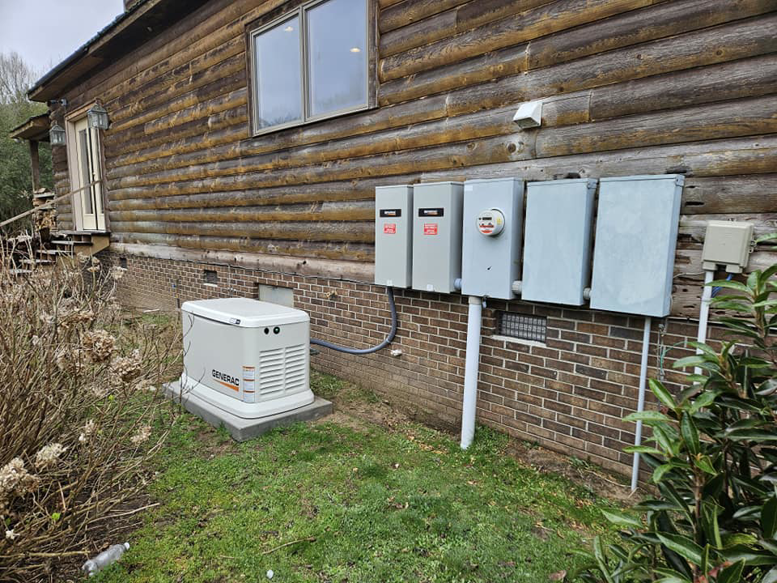 A residential Generac standby generator and electrical service panels installed by Jernigan Electrical Service Co., LLC in Windsor, NC.