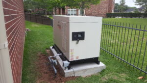 A Generac standby generator installed on a concrete pad next to a home by Peace Of Mind Services in Sag Harbor, NY