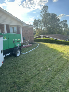 An electrician installing or connecting a Sunbelt Rentals generator to a residential home in Macon, GA, by Middle Georgia Electric, Inc.