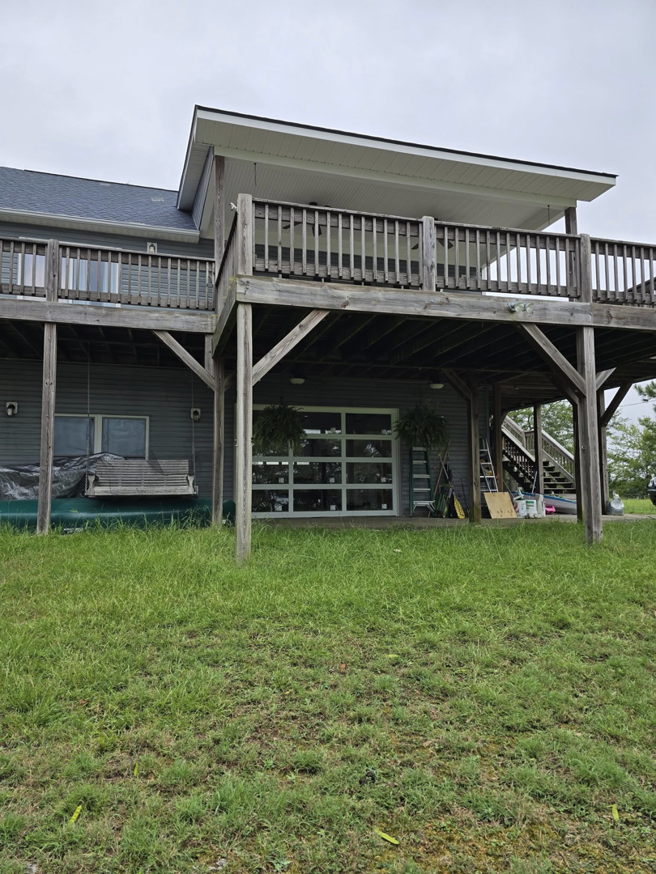A residential glass garage door installed under a deck by Coles Garage Door Service, LLC in West Columbia, SC.