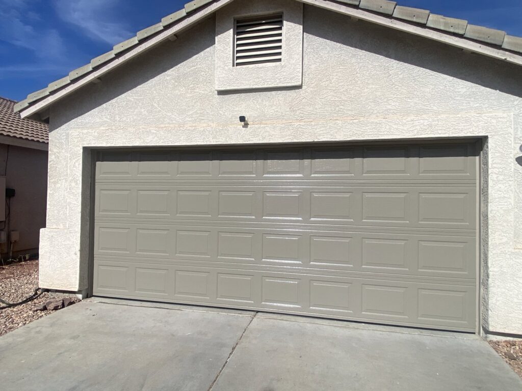 A residential gray paneled garage door installed by 4 Sons Garage Door in Phoenix, AZ.