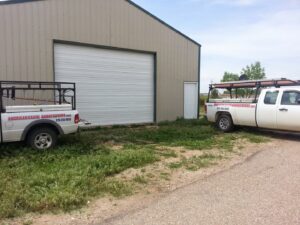 A newly installed grey garage door on a residential house by American Eagle Garage Doors in Greeley, CO.