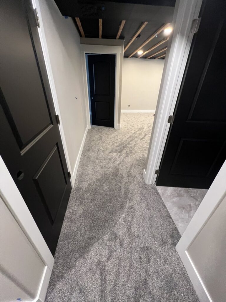 A residential hallway featuring new grey carpet installed by All about flooring utah in Salt Lake City, UT.