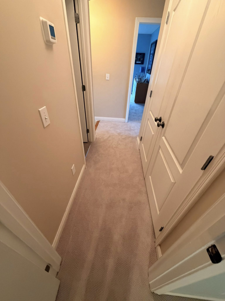 A freshly installed light-colored carpet in a residential hallway by A Step Above Flooring in Lexington, KY
