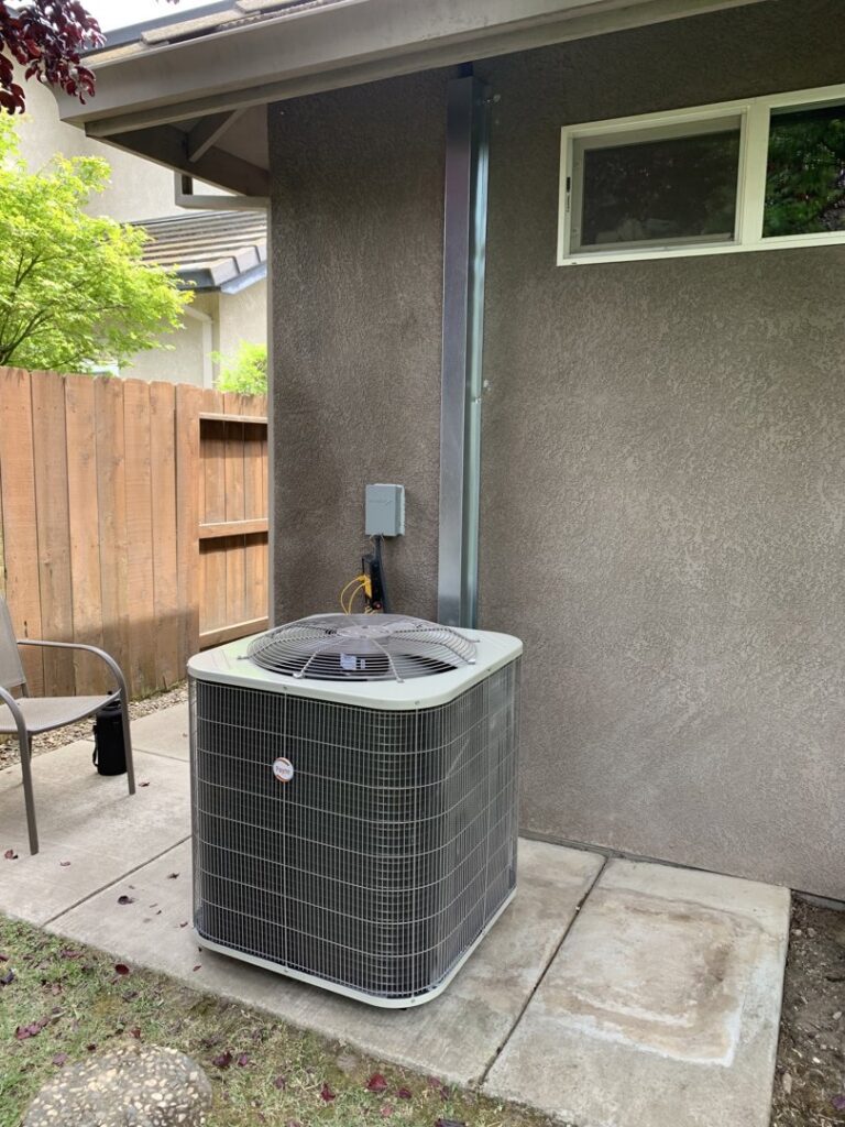 A residential outdoor HVAC condenser unit installed next to a home by Service Kings Heating and Air in Jamestown, ND.