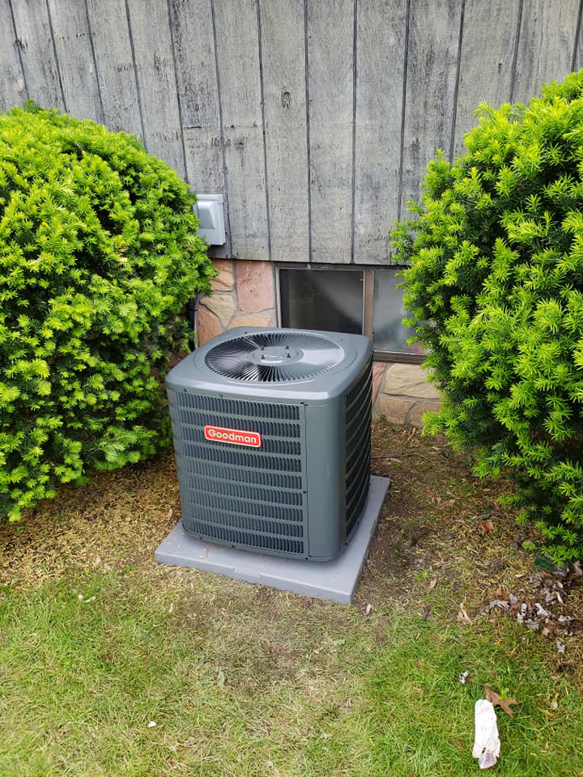 A Goodman residential HVAC condenser unit installed outside a home by J.M Heating, Air Conditioning and Refrigeration in Pittsburgh, PA.