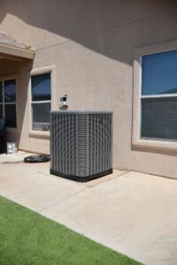 A residential outdoor HVAC condenser unit serviced by Ignitify Commercial Grade HVAC in El Paso, TX.