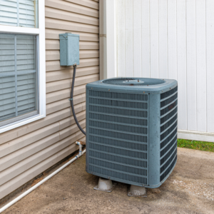 A residential HVAC condenser unit installed outside a home by M Heating & Cooling, Inc. in Green Bay, WI