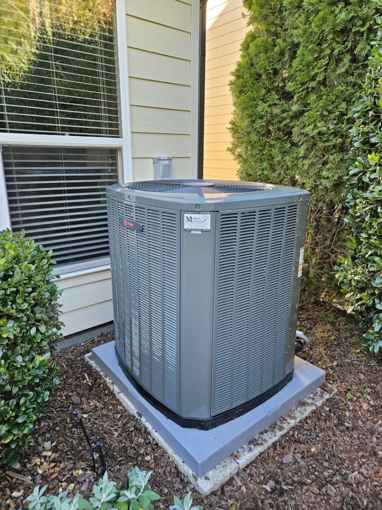 A newly installed or well-maintained residential HVAC condenser unit by Modern Mechanical HVAC in Garner, NC.