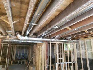 Residential HVAC ductwork installation in an unfinished basement by AccuMax Incorporated in Aurora, IL.