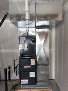 A residential HVAC furnace and air handler unit with ductwork installed in a new construction home by Integrity Heating And Air LLC in Nampa, ID