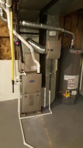 A residential HVAC system with a water heater and humidifier installed by Polar Aire Heating & Cooling in Olathe, KS