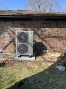 A residential HVAC unit installation completed by Symbiont Services next to a brick home in Englewood, FL.