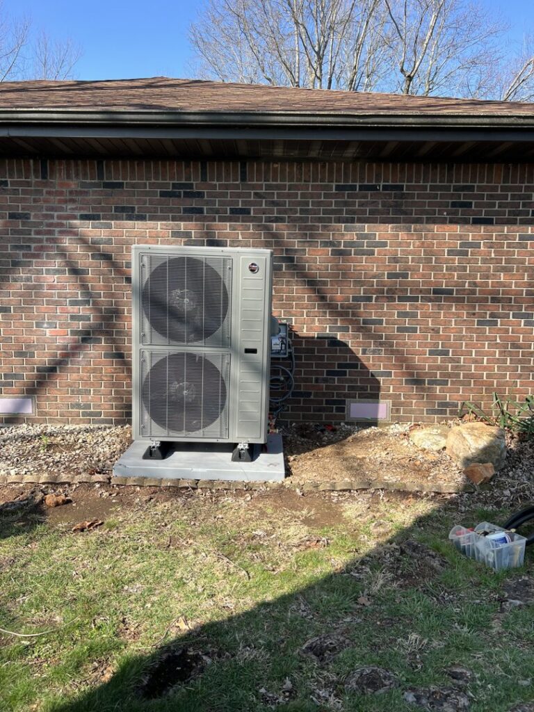 A residential HVAC unit installation completed by Symbiont Services next to a brick home in Englewood, FL.
